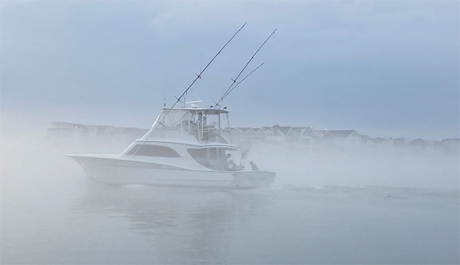 Boat in foggy water.